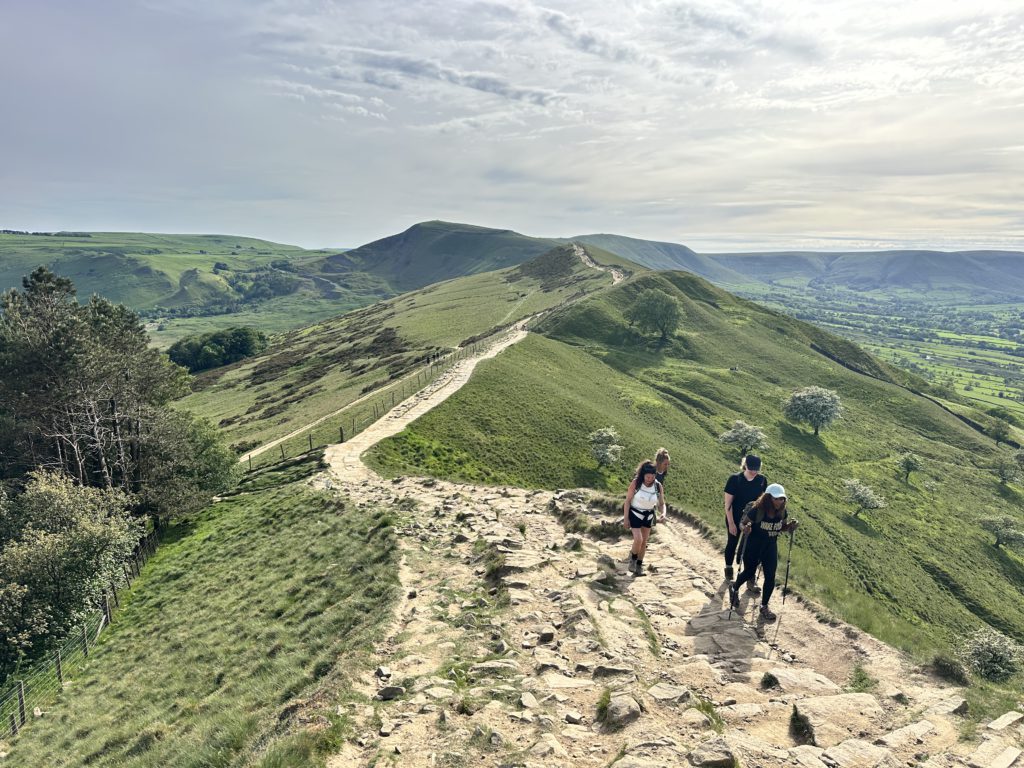 Group of women hikers walking along the Edale Skyline route in the Peak District